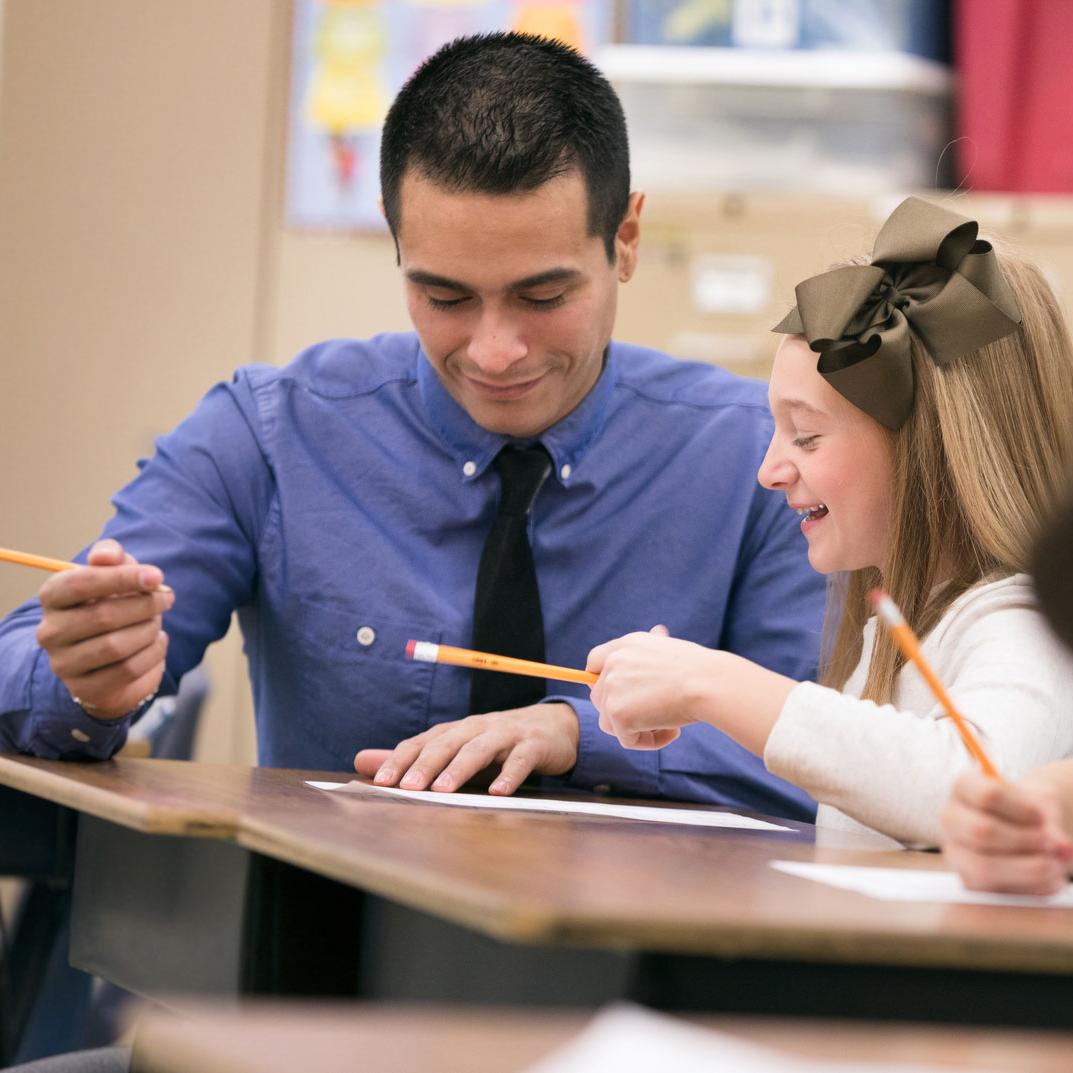 A teacher helps a student